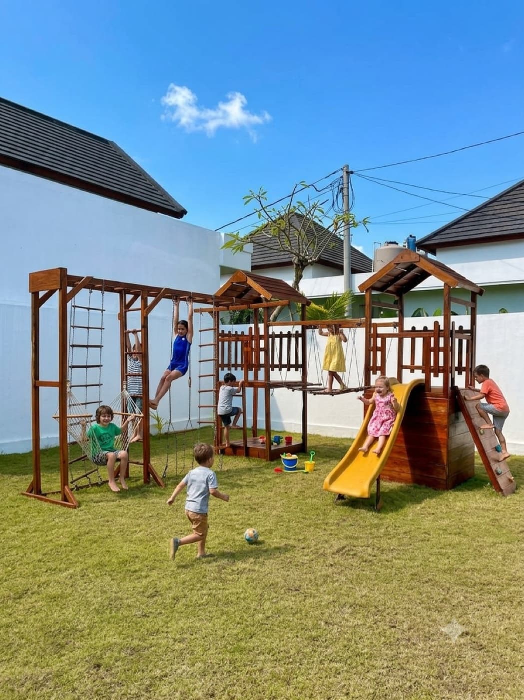 Children climbing, sliding and playing on the Jungle Kids wooden playground
