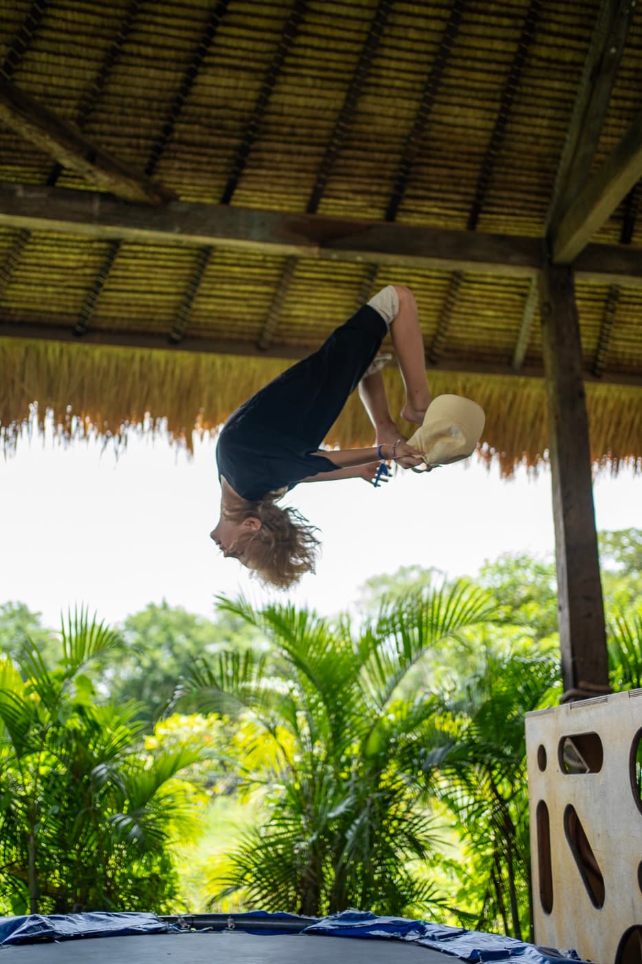 A child doing a backflip on the trampoline